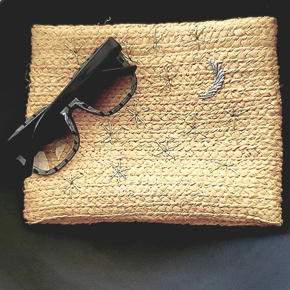 Bujibaja straw clutch with gold moon and silver stars embroidery.